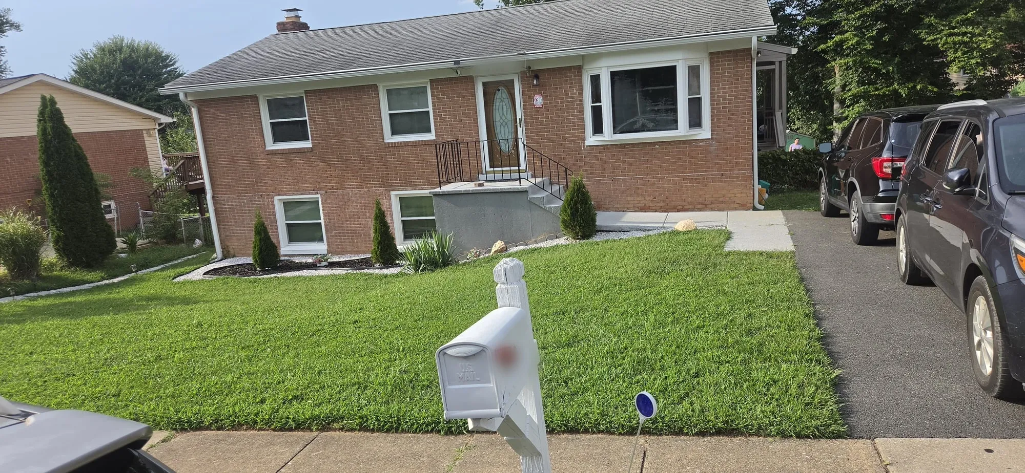 Freshly mowed front yard with trimmed shrubs and edged beds